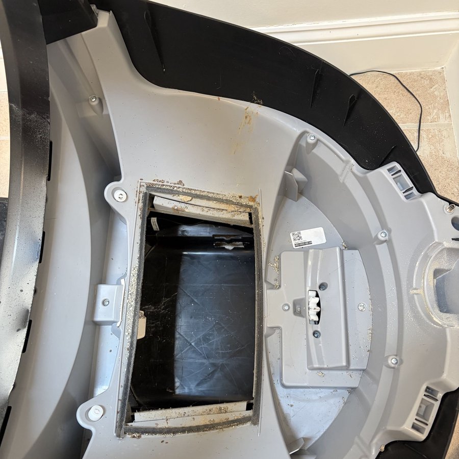 Automatic litter box before professional deep cleaning — waste and odor buildup